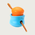 Load image into Gallery viewer, A view of the interlocked Large & X-Large Toppl toys, with a bully stick dog chew threaded through the round center openings of each toy.
