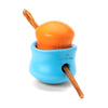 A view of the interlocked Large & X-Large Toppl toys, with a bully stick dog chew threaded through the round center openings of each toy.