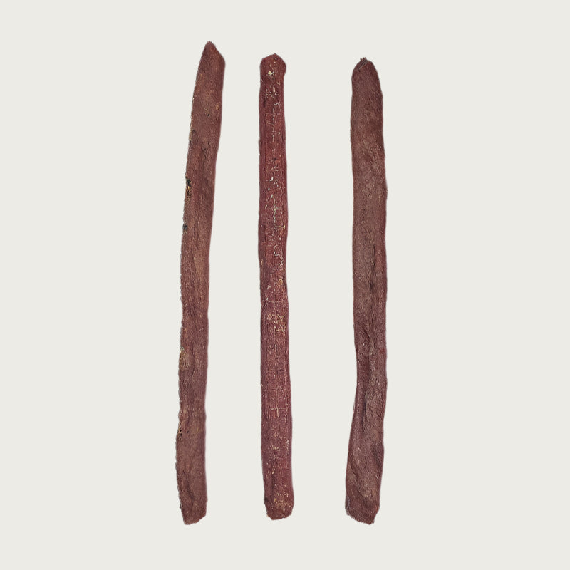 Three brown Bully Snap dog chew treats side by side. They look like sticks.