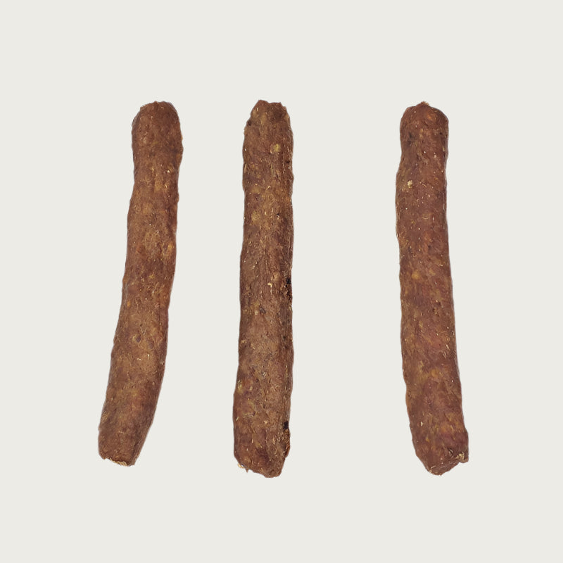 Three brown 5in Bully Snap dog chew treats side by side. They look like short sticks.