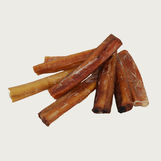 Stack of short bully stick dog chews to show natural variations in shape and color.