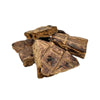 Closeup photo of a small pile of Wet Nose Buff Puffs dog treats. Product is varying sizes of square shaped, brown treats, ranging from approximately 2" - 4" wide.