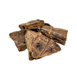 Closeup photo of a small pile of Wet Nose Buff Puffs dog treats. Product is varying sizes of square shaped, brown treats, ranging from approximately 2" - 4" wide.