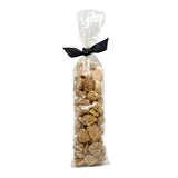 2.25 oz clear cellophane, tube-shaped bag of Wet Nose exclusive Bunny Drops dog treats, tied with black ribbon. Treats inside are pale brown in color, and shaped like pebbles of various sizes.