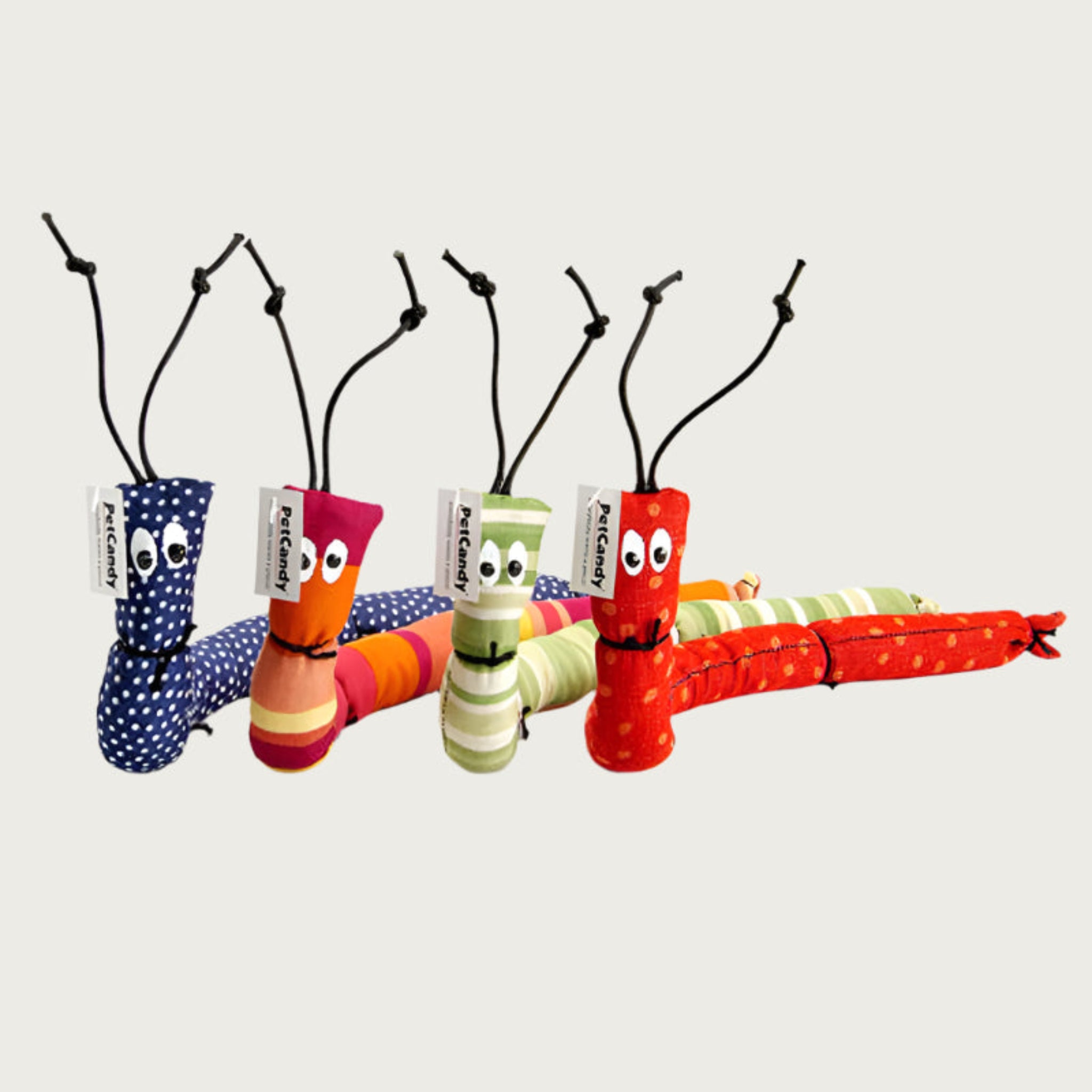 Colorful caterpillar-shaped cat toys with eyes and black string antennas.