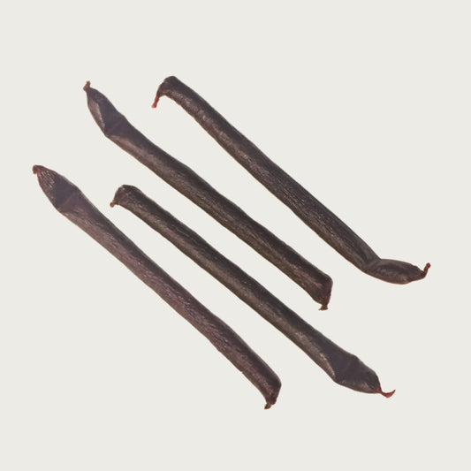 Four chicken links, side by side. They look like dark reddish brown sausages.
