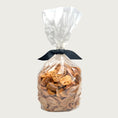 Load image into Gallery viewer, 1 lb clear cellophane bag of Wet Nose exclusive Chicken Nuggets dog treats, tied with black ribbon. Coin-shaped treats inside are a pale orangey-tan color.

