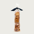 Load image into Gallery viewer, 3 oz clear cellophane, tube-shaped bag of Wet Nose exclusive Chicken Nuggets dog treats, tied with black ribbon. Stacked coin-shaped treats inside are a pale orangey-tan color.

