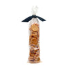 3 oz clear cellophane, tube-shaped bag of Wet Nose exclusive Chicken Nuggets dog treats, tied with black ribbon. Stacked coin-shaped treats inside are a pale orangey-tan color.
