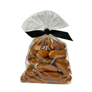 7 oz clear resealable bag of Wet Nose exclusive, Chicken Smokies dog treats, tied with black ribbon. Product inside is light brown colored links. 