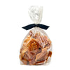 8 oz clear cellophane bag of Wet Nose exclusive Chicken Strips dog treats, tied with black ribbon. Inside are strips of chicken tenders, that are pale orangey-tan in color.