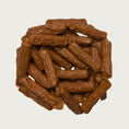 Load image into Gallery viewer, Close-up photo of a small stack of Wet Nose Duck Smokies dog treats. They are medium brown colored links, measuring about 2.5" long.
