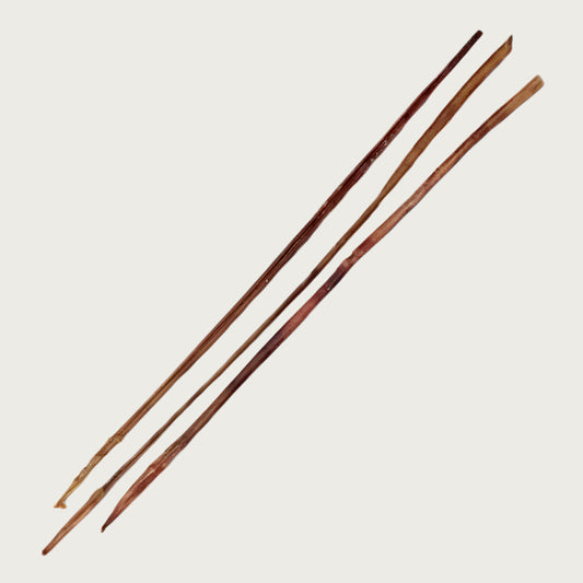 Three thick & long bully stick dog chews, shown side by side to view natural variations in shape and color.