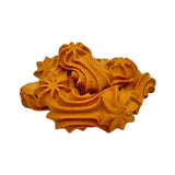 Closeup of a small pile of Wet Nose Goobers dog treats. They are tan, oblong shaped, and have a swirl texture on top. They measure about 3" long.