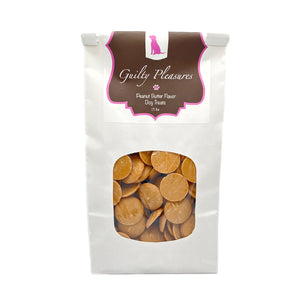 1.5 lb white craft paper bag of Wet Nose Guilty Pleasures Peanut Butter Flavor Dog Treats. Clear window on bag shows tan, disc-shaped treats inside.