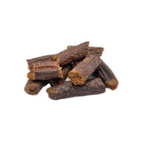 A close-up photo of a small stack of Wet Nose Misfit Duck Sticks dog treats. They are reddish brown in color about 2" long, with a slightly crumbly looking texture.