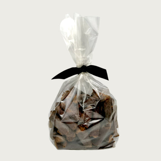 12 oz clear cellophane bag of Wet Nose exclusive, Misfit Duck Sticks dog treats, tied with black ribbon. 2" sized reddish/brown sticks. 