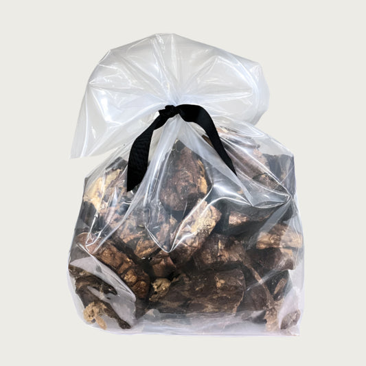 2 lb clear resealable bag of Wet Nose exclusive Moo Munch dog treats, tied with black ribbon. Product inside is visible; large and small square shaped, brown treats.