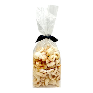 2 oz clear cellophane bag of Wet Nose exclusive Moo Rinds dog treats, tied with black ribbon. Treats inside are ivory colored, and look like thick, curled chips.