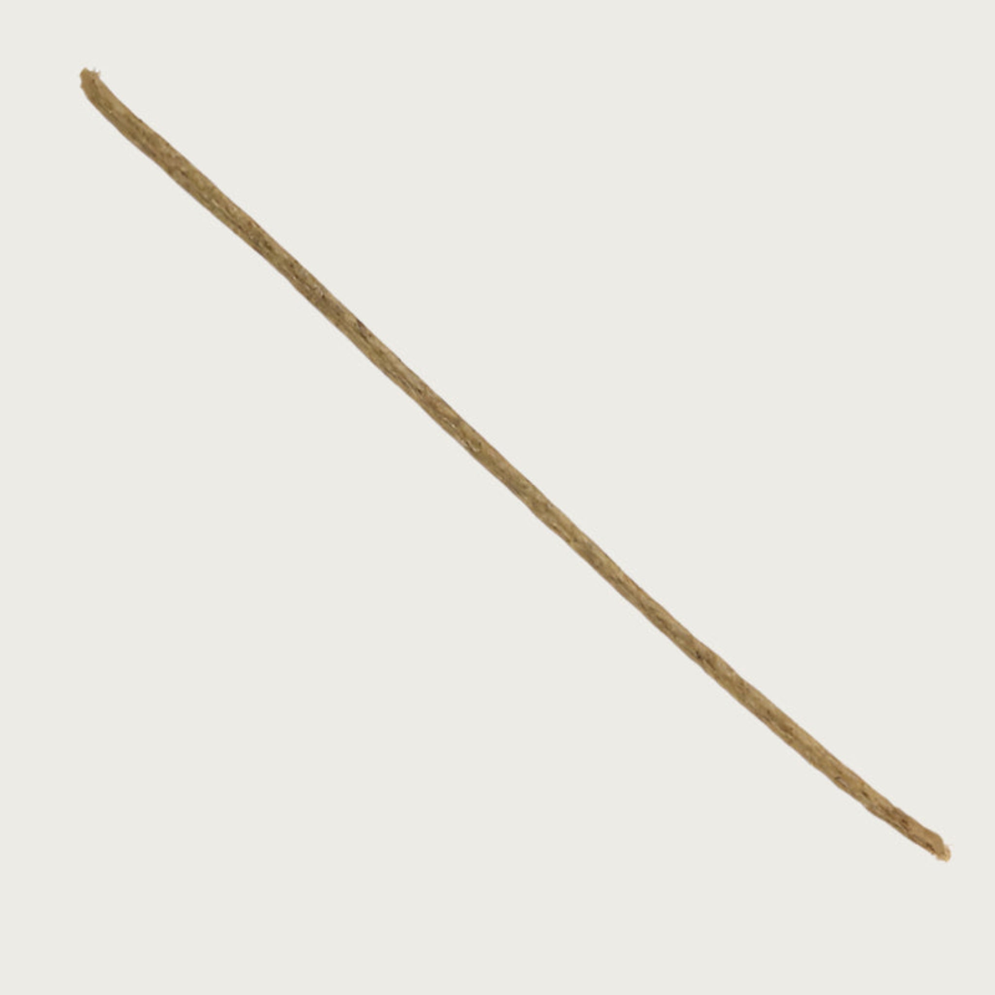 Dark tan colored joy stick dog chew. It looks like a long, straight, thin tree branch.
