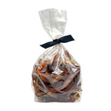 8 oz clear cellophane bag of Wet Nose exclusive Road Runner Stix dog treats, tied with black ribbon. Product inside is brown, rectangular shaped strips.