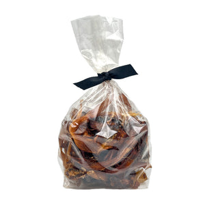 8 oz clear cellophane bag of Wet Nose exclusive Road Runner Stix dog treats, tied with black ribbon. Product inside is brown, rectangular shaped strips.