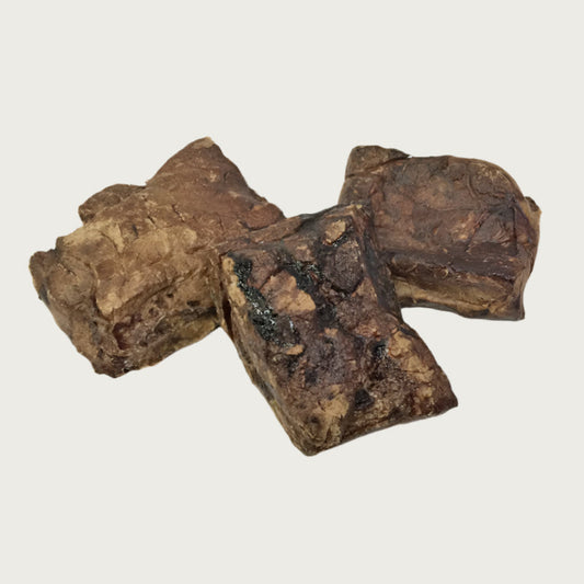 Three pieces of dark brown moo munch side by side to show size & color variations.