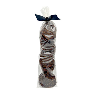 Clear cellophane bag of 15 count Wet Nose exclusive Sliders dog treats, tied with black ribbon. Product inside is round, brown discs.