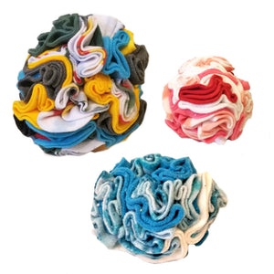A group of three sizes of Snuffle Ball dog and cat toy from Wet Nose. The balls are fleece, and built with tightly packed folds to hold treats.