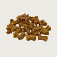 Load image into Gallery viewer, Close-up photo of a small pile of Wet Nose Teeny Meaties dog treats. They are tiny, brown, bone-shaped treats, about 1/2" wide and 1/4" thick.
